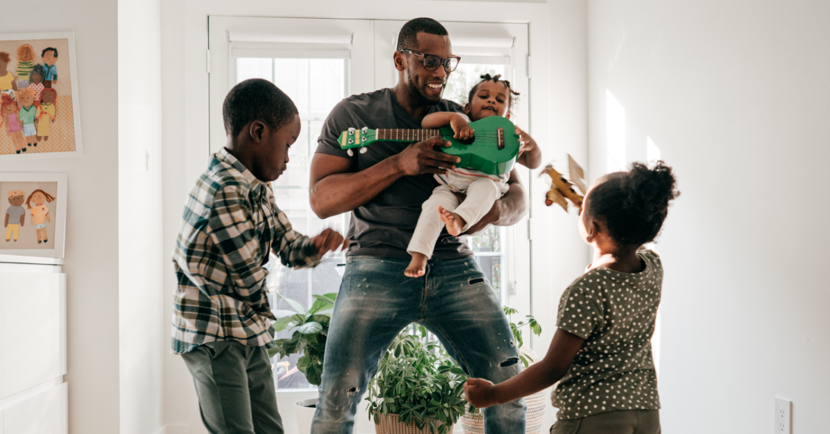 Father-and-children-laughing-and-playing-together