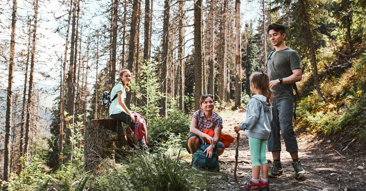 Family-talking-and-hiking-in-woods