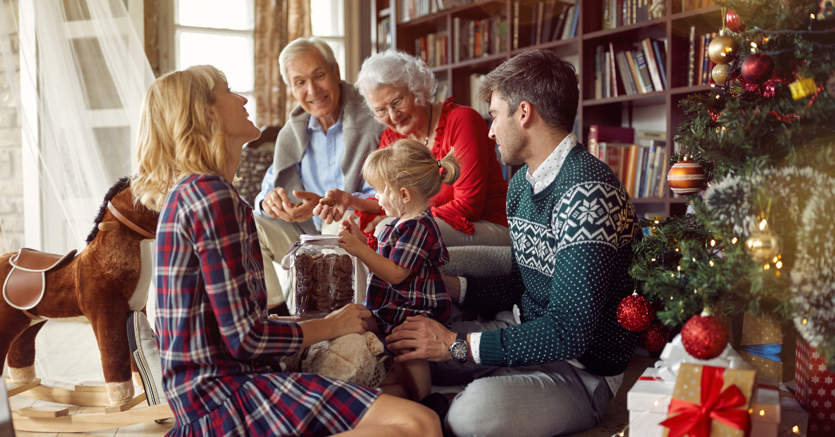 Family laughing around the Christmas tree