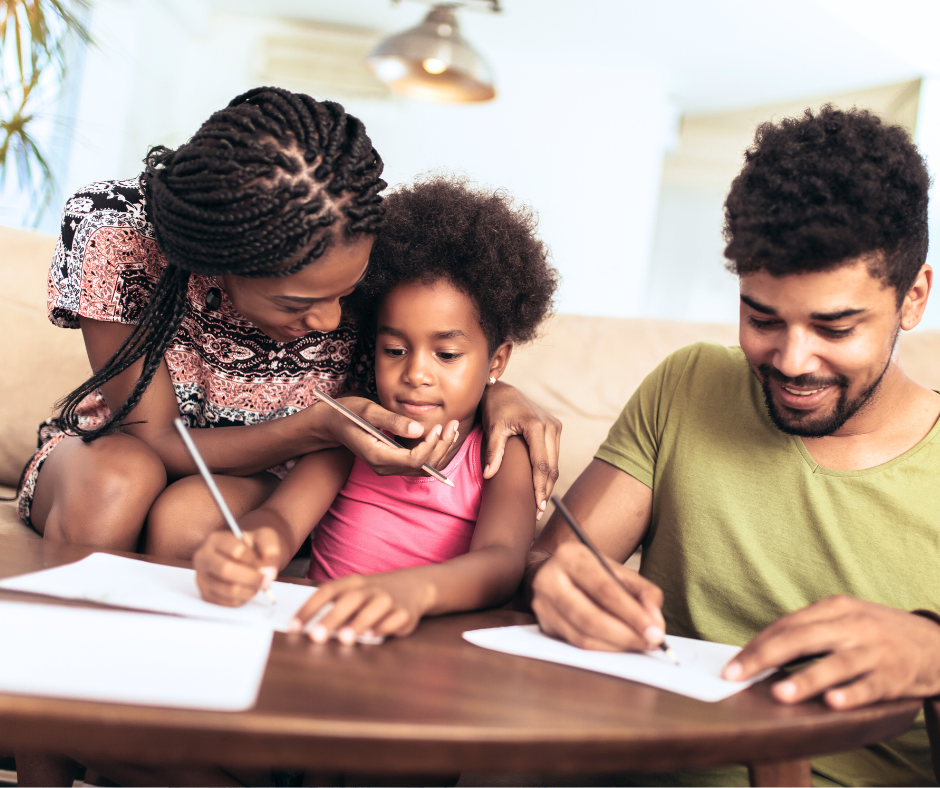 Family of three writing together