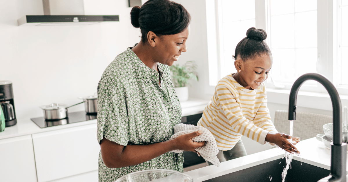 Mother and daughter wash dishes