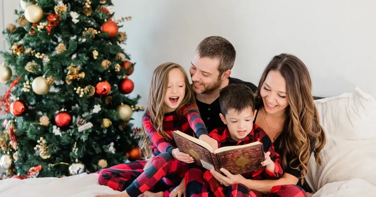 Family Reading by Christmas Tree