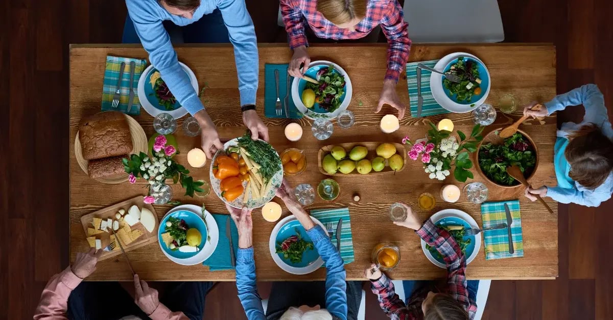Family Sitting Around Dinner Table