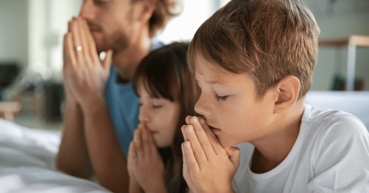 Father and children praying