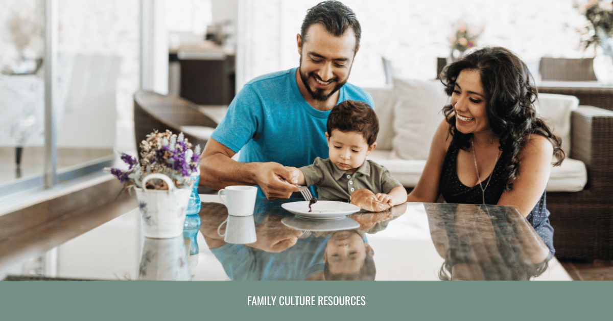 Young parents holding baby at family dinner