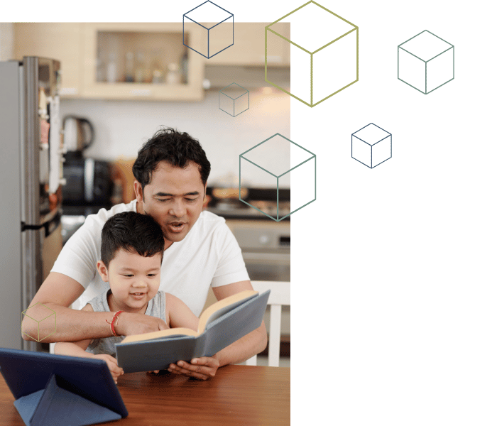asian-father-reading-to-son-at-table