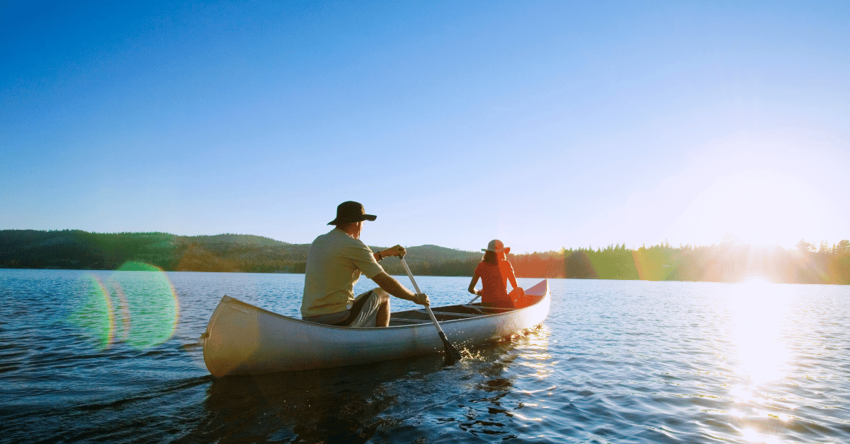 Man and woman canoeing on a lake