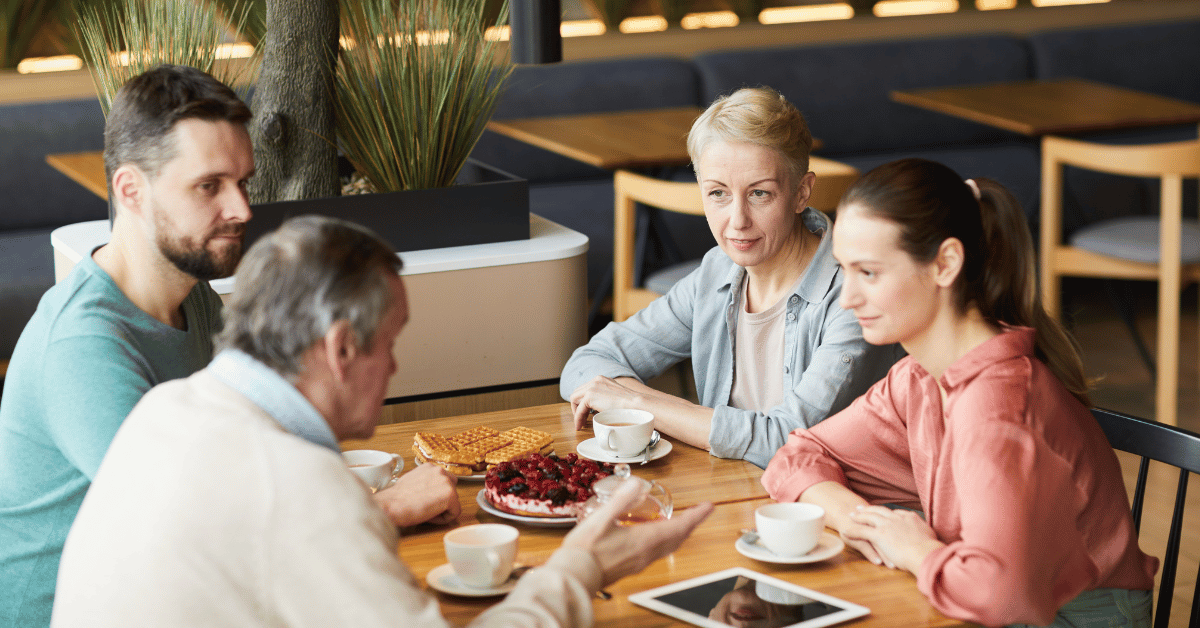 older parents meeting with adult children over a meal