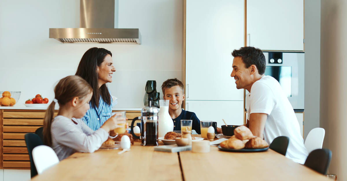 family-eating-breakfast-and-laughing