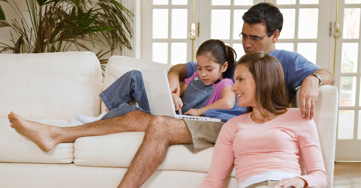 parents-and-daughter-sitting-on-couch