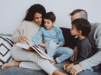 Parents with two young boys on couch