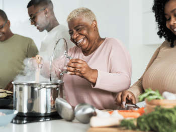 African american family cooking dinner with adult kids