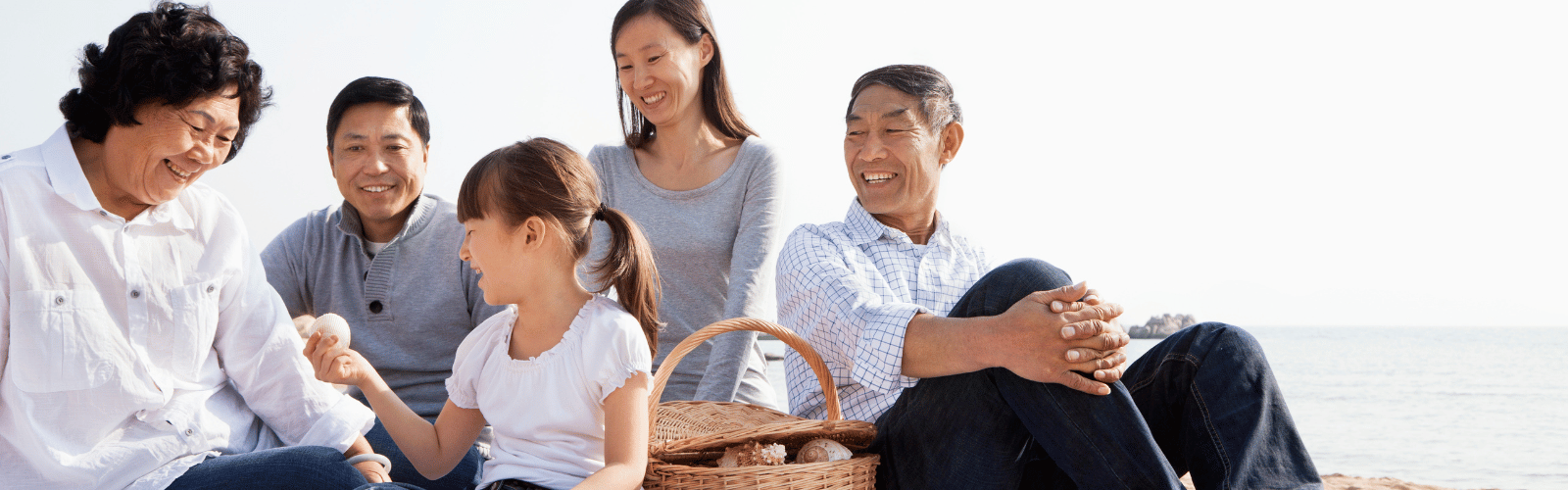 asian family having a picnic on the beach