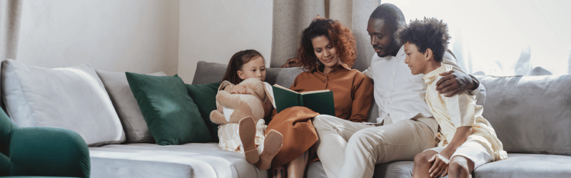 family-reading-book-on-couch